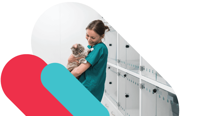 Female vet holding a dog with academy branding